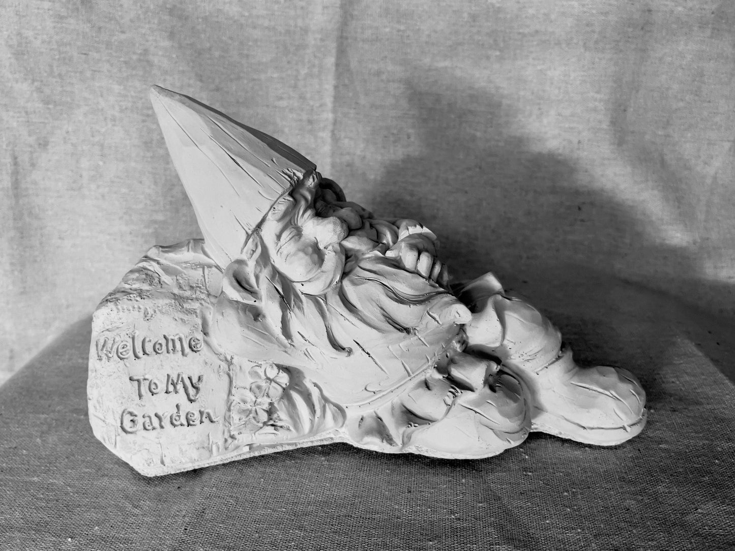 Lazy Garden Gnome on a Welcome Sign Statue